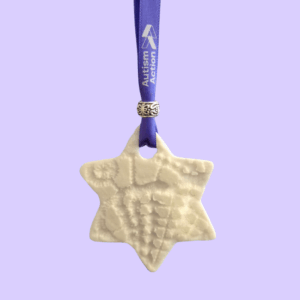 Star decoration attached to a purple Autism Action ribbon